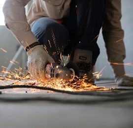 Worker with metal saw